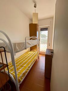 a bunk bed in a room with a window at Circeo-Terracina Villa Sul Mare in Terracina