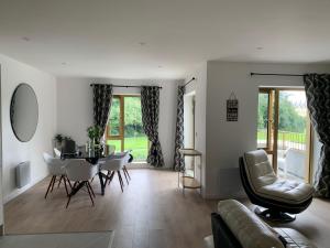 a living room with a table and chairs at Bushmills Boutique Apartment in Bushmills