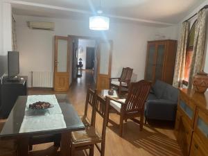 a living room with a couch and a table at Hostal Casa López in La Zarza