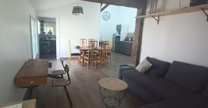 a living room with a couch and a table at Pause Champêtre in Saint-Aignan-Grand-Lieu