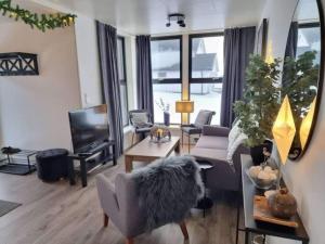 a living room with a couch and a chair at Sommarøy Aurora apartment in Tromsø