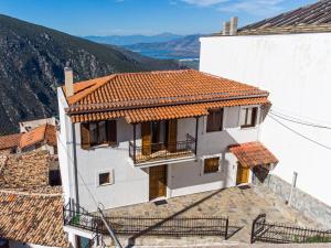 a white house with a red tile roof at Delphi View - 3 Bedrooms apartment, fully equipped in Delphi