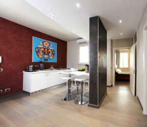 a kitchen with a counter and a bar with stools at B&B Opera in Parma
