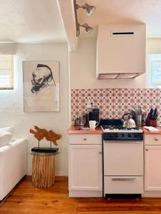 a kitchen with a stove and a counter top at Dos Hermanas Casita 2 Downtown Courtyard in Santa Fe