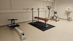 a room with a gym with two machines and a sink at Hotelli Sammatti in Lohja