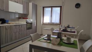 a kitchen with a table and chairs in a room at Bed and Breakfast Arcobaleno - Rieti in Rieti