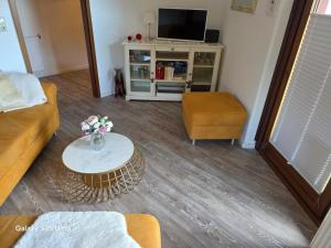 a living room with a couch and a table at PEMATRA FeWo Nordlicht in Travemünde