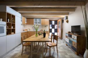 a kitchen with a wooden table and chairs at Holiday Home Bo in Rovinj
