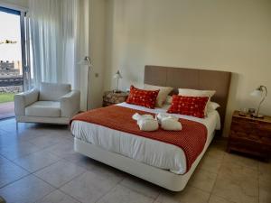 a bedroom with a bed with two towels on it at Villa La Pintora in Playa de Santiago +25 photos