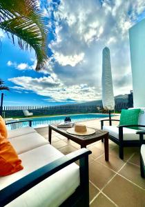 a patio with a view of the ocean on a building at Villa La Pintora in Playa de Santiago