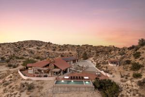 an aerial view of a house in the desert at Las Rocas By The Cohost Company in Yucca Valley