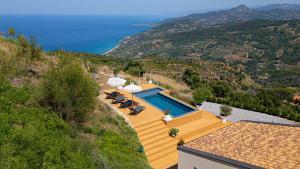 a villa with a swimming pool on a hill at Villa Magliolo Panoramic Luxury Retreat in Cefalù