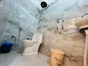 a bathroom with a toilet and a sink at Hotel Jyoti Stay Inn 10 Min to Ram Tample in Ayodhya