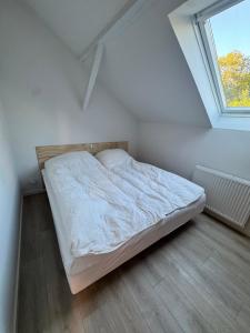 a bed in a room with a window at Vognstrupgaard in Silkeborg