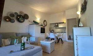 a living room with a couch and a kitchen at Bougainvilla in Costa Paradiso +35 photos