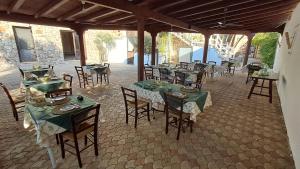 a group of tables and chairs in a patio at Masseria Artemisia in Torre San Giovanni Ugento
