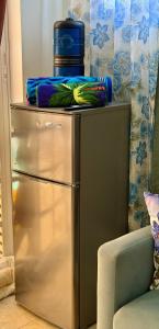 a metallic refrigerator with a cooler on top of it at The PoolSide Pad- 5 mins from Airport & Beaches in Bon Accord