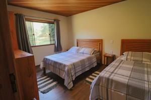 En eller flere senge i et værelse på Casa Raizes da Natureza