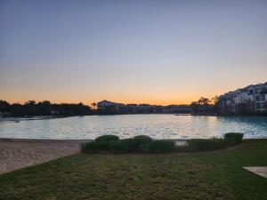 a large body of water with a sunset in the background at 1 Bed Crystal Lagoon Escape in Pretoria +21 photos