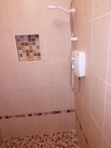a shower in a bathroom with a window at Aunty Shea's Getaway in Graigue +4 photos