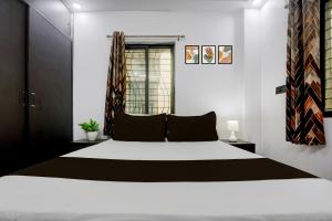a bedroom with a large bed and a window at Hotel O Swarun and Banquet Hall in Gulzārbāgh