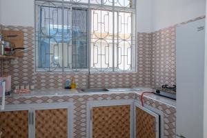 a kitchen with a sink and a window at Tulizo Villas Paje in Paje