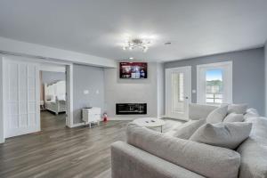 a living room with a couch and a fireplace at Dells Lakefront Luxe Haven in Wisconsin Dells