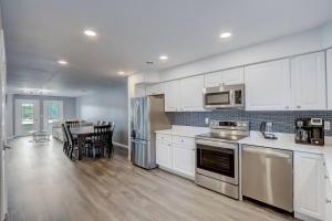 a kitchen with white cabinets and a table with chairs at Dells Lakefront Luxe Haven in Wisconsin Dells