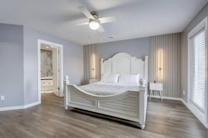 a bedroom with a white bed and a ceiling fan at Dells Lakefront Luxe Haven in Wisconsin Dells +51 photos