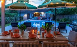 a table with candles on it in front of a pool at Savannah Retreat with Pool,Golf,Hot tub, Sleeps 14 in Savannah