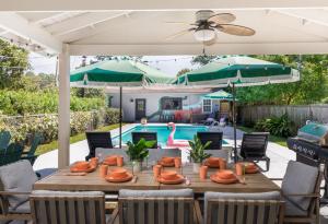 a patio with a table and chairs and a pool at Savannah Retreat with Pool,Golf,Hot tub, Sleeps 14 in Savannah
