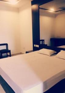 Ένα ή περισσότερα κρεβάτια σε δωμάτιο στο Hotel Grand Punjab