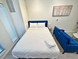 a bedroom with a bed and a blue couch at Azure Oasis Studio in Des Moines