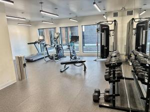 a gym with treadmills and exercise bikes in it at Azure Oasis Studio in Des Moines