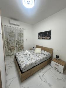 En eller flere senge i et værelse på Corso Italia Holiday Home