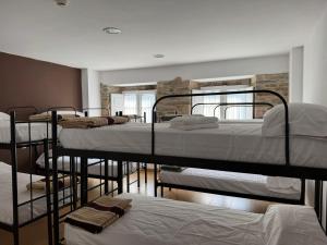 a group of bunk beds in a room at Albergue Internacional in Sarria