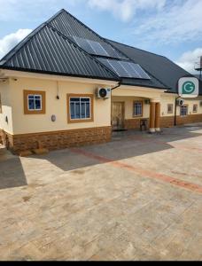 a building with solar panels on top of it at Ohio city hotel in Owerri