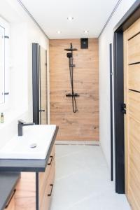 a bathroom with a sink and a shower at Apartamenty nad Starynką in Głuchołazy