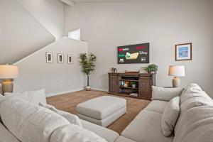 a living room with a couch and a tv at Wasatch Peak Chateau Ro3, Pool, Hot Tub in Mountain Green