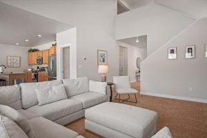 a living room with a couch and a table at Wasatch Peak Chateau Ro3, Pool, Hot Tub in Mountain Green