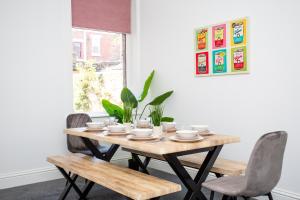 a dining room table with chairs and a wooden table at Vacant Nests The Fredrick Close To Sea Front in Seaham