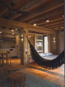 a hammock in a room with a kitchen at Loft kineki 6 in Puerto Escondido