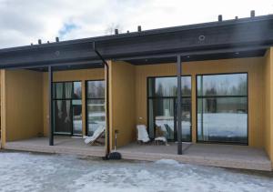 a house with large windows and a patio at Nordic Wooden House in Rovaniemi