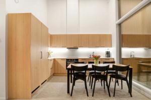a kitchen with a table and black chairs at Nordic Wooden House in Rovaniemi
