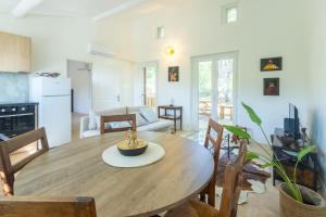 a kitchen and living room with a wooden table and chairs at Le Chopin - Aix in Aix-en-Provence