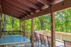 a deck with a ping pong table and chairs at Adventure Cabin! Fire Pit, State Park, Fishing, Mtn Views, Hot Tub, WiFi in Jefferson