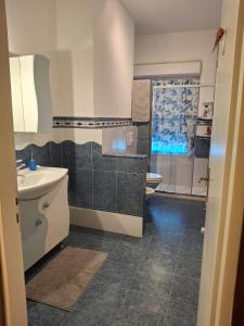 a bathroom with a sink and a toilet at Dimora Angelica in Statte +7 photos