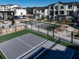a tennis court with two tennis courts at Wasatch Peak Chateau Ro3, Pool, Hot Tub in Mountain Green
