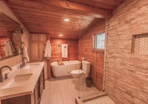 a bathroom with a toilet and a sink and a tub at Erik's Ranch in Livingston +101 photos