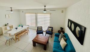 a living room with a blue couch and a table at Casa Bella in Playa del Carmen